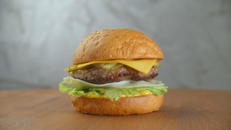 A-delicious-cheeseburger-served-on-a-wooden-platter.