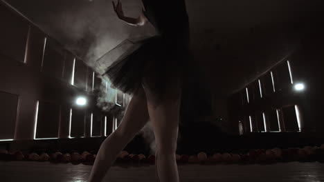 Close-up-Shot-of-Ballerina's-Legs.-She-Dances-on-Her-Pointe-Ballet-Shoes.-She's-Wearing-Black-Tutu-Dress.-Shot-in-a-Bright-and-Sunny-Studio.-In-Slow-Motion.