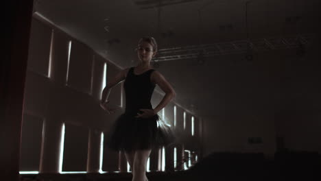 SLOW-MOTION:-Ballerina-dancing-in-Pointe-shoes-on-stage-in-smoke-in-the-dark-light-back-view.-the-camera-moves-on-gimbal