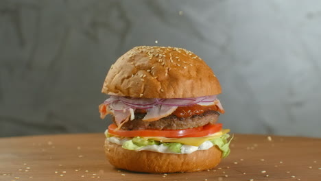 White-sesame-seed-falling-into-bun-in-slow-motion.-Bun-with-sesame-for-making-hamburger
