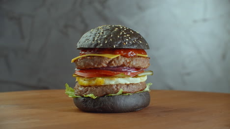 Black-burger.-With-greean-vegetable.-Black-Burger-On-Wooden-Table