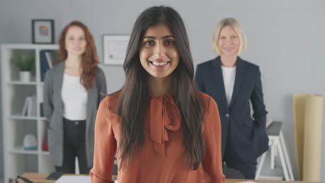 Portrait-Of-Smiling-Female-Multi-Racial-Business-Team-Standing-In-Office