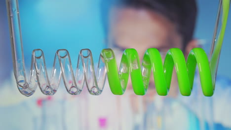 Changing-the-acid-color.-Close-up-and-slow-motion-of-yellow-blue-green-liquid-spiraling-horizontally-right-to-left-in-a-scientific-glass-condenser.-biofuel-processing-through-a-laboratory-condenser.-High-quality-4k-footage