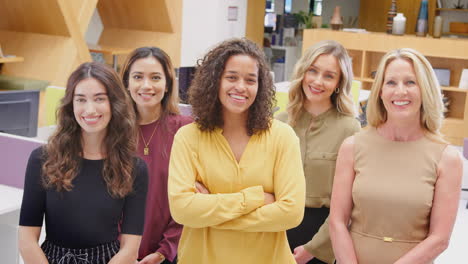 Portrait-Of-Smiling-Multi-Cultural-Female-Business-Team-Standing-In-Modern-Open-Plan-Office