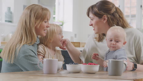 Same-Sex-Female-Couple-Having-Healthy-Breakfast-At-Home-With-Daughter-And-Baby-Son