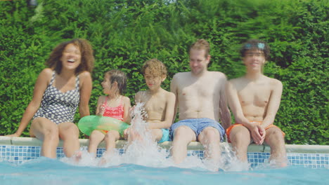 Portrait-Of-Multi-Racial-Family-Relaxing-In-Swimming-Pool-On-Summer-Vacation-Shot-From-Underwater