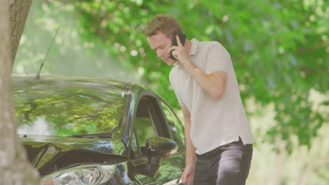 Man-Getting-Out-Of-Smoking-Car-And-Inspecting-Accident-Damage-Before-Calling-Emergency-Services
