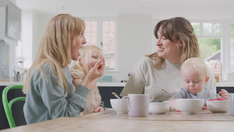 Same-Sex-Female-Couple-Having-Healthy-Breakfast-At-Home-With-Daughter-And-Baby-Son