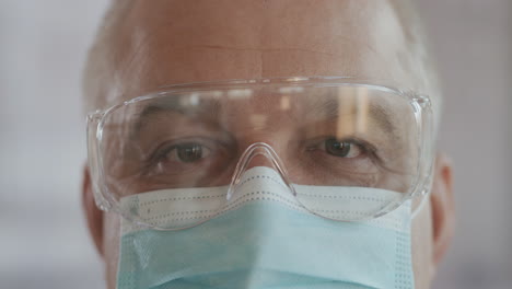 Portrait-of-confident-doctor-woman-face-close-up.-eyes-with-safety-glasses-and-protective-mask.-Research-Laboratory-Officer.-2019-Novel-Coronavirus-(2019-nCoV)-COVID-19-pandemic-isolation-concept.