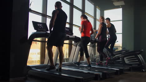 Healthy-People-running-on-machine-treadmill-at-fitness-gym-Work.-Out-concept.-People-doing-cardio-training-on-treadmill-in-gym