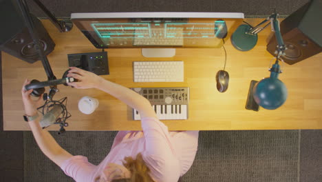Overhead-View-Of-Female-Musician-At-Computer-In-Studio-Finishing-Work-And-Turning-Off-Lights