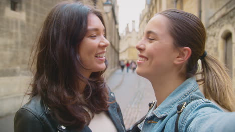 POV-Shot-Of-Same-Sex-Female-Couple-Pose-For-Selfie-As-They-Visit-Oxford-UK-Together