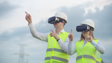 High-voltage-power-lines-under-the-control-of-two-engineers-using-virtual-reality-to-control-power.-Alternative-energy-sources-in-a-modern-city.