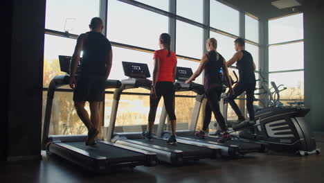 Young-men-men-and-women-walking-on-treadmills-in-the-gym-in-slow-motion.