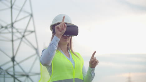 High-voltage-power-lines-controlled-by-a-female-engineer-using-virtual-reality-to-control-power.-Alternative-energy-sources-in-a-modern-city