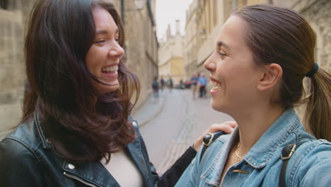 POV-Shot-Of-Same-Sex-Female-Couple-Pose-For-Selfie-As-They-Visit-Oxford-UK-Together