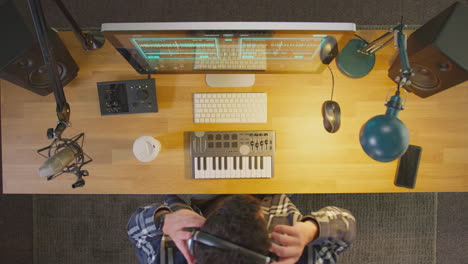 Overhead-View-Of-Male-Musician-At-Computer-In-Studio-Finishing-Work-And-Turning-Off-Lights