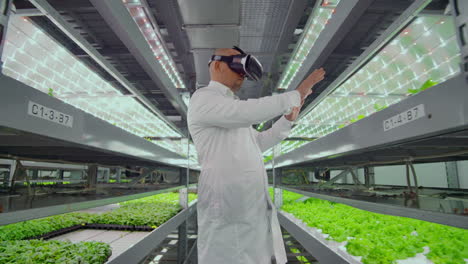 Vertical-hydroponic-plantation-of-a-man-in-a-white-coat-using-virtual-reality-technology-simulating-the-operation-of-the-interface.