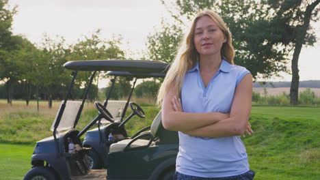 Portrait-Of-Female-Golfer-Standing-By-Buggy-On-Golf-Course