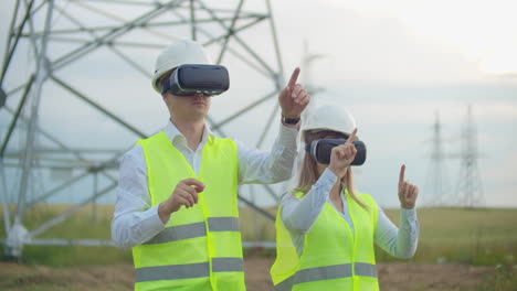 Engineers-work-with-augmented-reality-using-3D-virtual-reality-glasses.-Female-and-male-engineer-works-with-VR-glasses-while-a-man-holds.