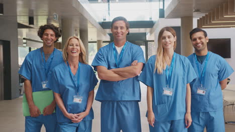 Portrait-Of-Multi-Cultural-Medical-Team-Wearing-Scrubs-Standing-Inside-Hospital-Building