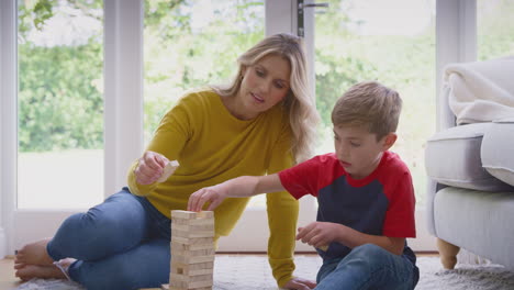 Mother-And-Son-At-Home-Playing-Game-Stacking-And-Balancing-Wooden-Blocks-Together