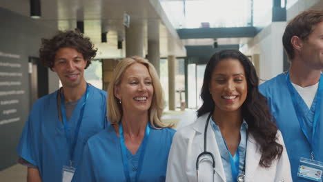 Portrait-Of-Multi-Cultural-Medical-Team-Wearing-Uniform-Standing-Inside-Hospital-Building