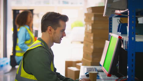 Male-And-Female-Workers-Using-Computer-Terminals-And-Moving-Boxes-In-Distribution-Warehouse