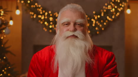 Close-up-of-grey-haired-Santa-Clause-in-glasses-looking-at-camera.-Headshot-portrait-of-funny-old-kind-bearded-Santa-Claus-face.-Saint-Nicholas-greeting-on-Merry-Christmas.-High-quality-4k-footage