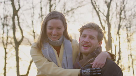 Portrait-Of-Romantic-Couple-With-Woman-With-Prosthetic-Hand-Hugging-in-Winter-Or-Autumn-Countryside