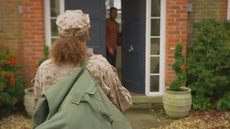 American-Female-Soldier-Returns-Home-To-Family-On-Leave-Hugging-Husband-Outside-House