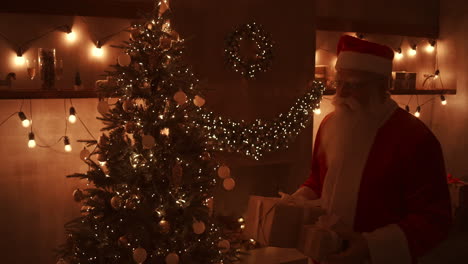 On-Christmas-night-Santa-delivers-gifts-to-homes-while-everyone-is-asleep.-Santa-will-leave-gifts-under-the-Christmas-tree-in-the-decorated-house.-High-quality-4k-footage