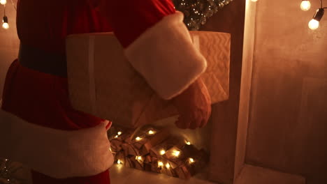 Close---up-of-Santas-hand:-brings-gifts-under-the-Christmas-tree-for-children.-Give-gifts-to-children-on-Christmas-night.-Santa-puts-a-gift-under-the-Christmas-tree.-High-quality-4k-footage