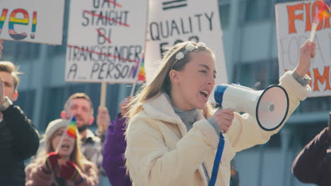 Group-Of-Protestor-With-Megaphone-Waving-Flags-On-Demonstration-March-For-Gender-Equality