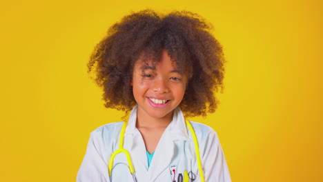 Studio-Portrait-Of-Boy-Dressed-As-Doctor-Or-Surgeon-Against-Yellow-Background