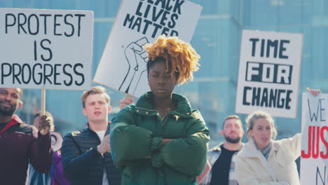 Portrait-Of-Female-Protestor-Amongst-Marchers-With-Placards-On-Black-Lives-Matter-Demonstration