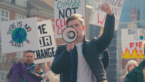 Group-Of-Protestors-With-Placards-And-Megaphone-On-Demonstration-March-Against-Climate-Change