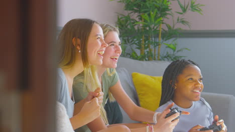 Group-Of-Teenage-Girl-Friends-Gaming-And-Hanging-Out-In-Bedroom-At-Home