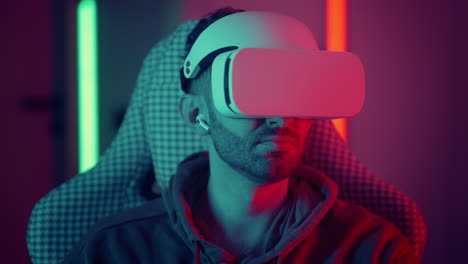 Man-watching-movie-using-virtual-reality-glasses.-man-makes-swiping-and-touching-moves-with-hands-playing-VR-game.-High-quality-4k-footage
