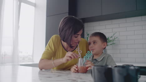 Mother-and-son-drink-the-juice-of-the-tubes