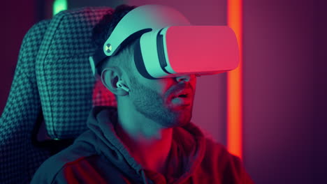 Man-watching-movie-using-virtual-reality-glasses.-man-makes-swiping-and-touching-moves-with-hands-playing-VR-game.-High-quality-4k-footage