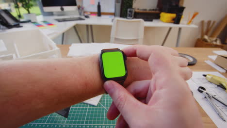 Close-Up-POV-Shot-Of-Male-Office-Worker-At-Desk-Using-Green-Screen-Smart-Watch