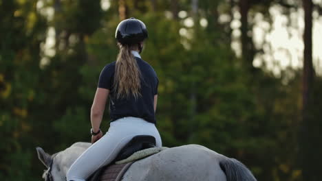 Back-view-of-rider-on-a-horse.-Back-view-of-a-rider-with-a-horse-slow-motion