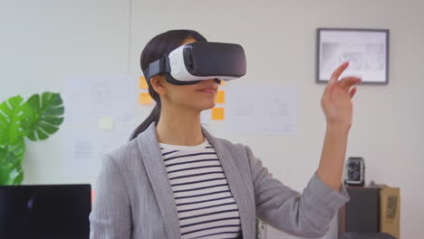 Female-Architect-In-Office-Using-VR-Headset-To-Design-New-Building