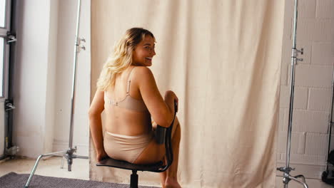 Studio-Shot-Of-Confident-Natural-Woman-In-Underwear-Promoting-Body-Positivity-Spinning-On-Chair