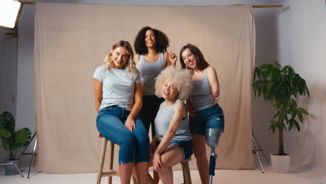 Portrait-Of-Casually-Dressed-Women-Friends-One-With-Prosthetic-Limb-Promoting-Body-Positivity-Studio