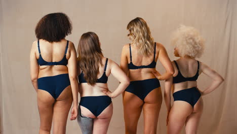 Rear-View-Of-Women-Friends-One-With-Prosthetic-Limb-In-Underwear-Promoting-Body-Positivity