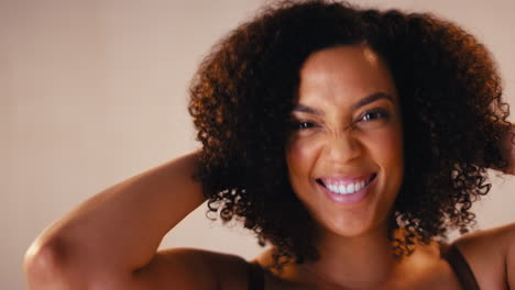 Studio-Head-And-Shoulders-Shot-Of-Laughing-Natural-Woman-Promoting-Body-Positivity