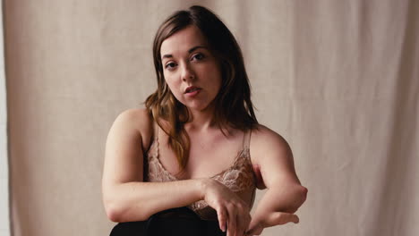 Studio-Shot-Of-Natural-Woman-With-Prosthetic-Limb-In-Underwear-Promoting-Body-Positivity-On-Chair