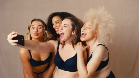 Group-Of-Diverse-Body-Positive-Women-Friends-In-Underwear-Posing-For-Selfie-On-Mobile-Phone